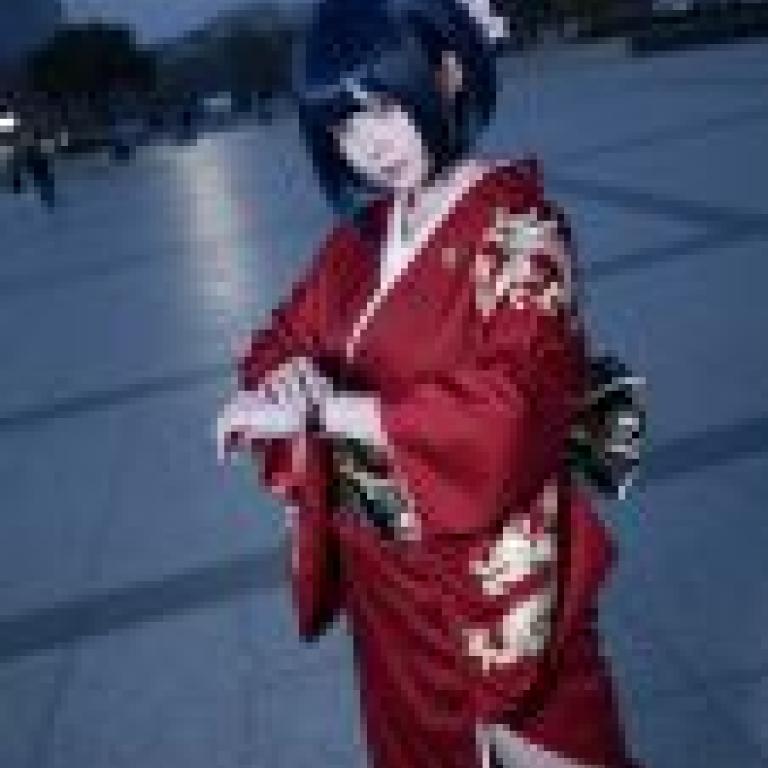 The Phantom of the Red Kimono，Asian woman in red kimono standing outdoors with phone on left wrist.