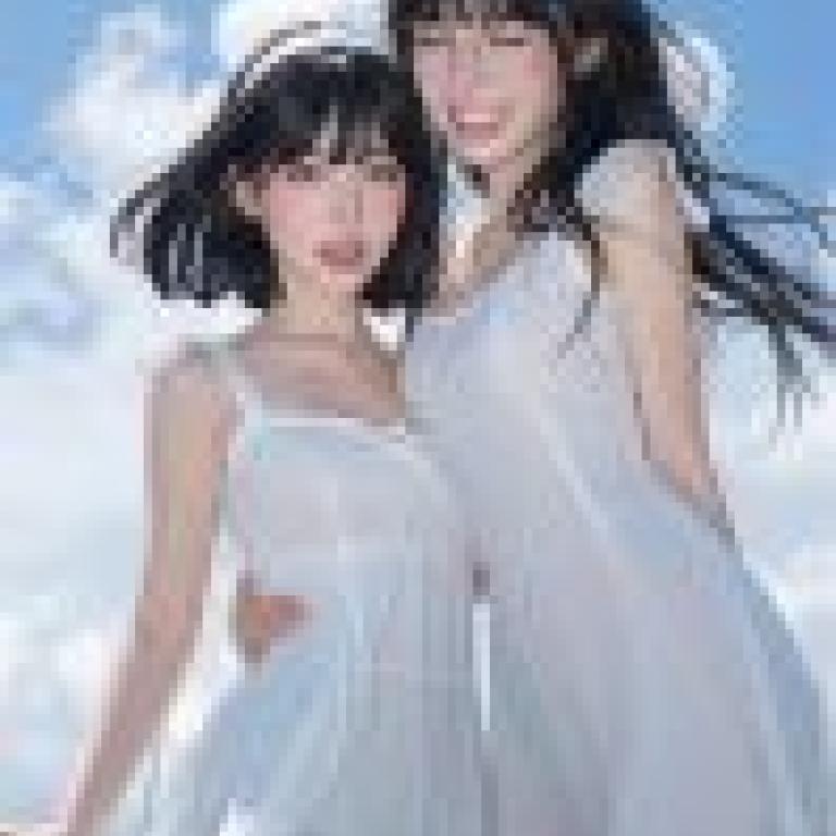 beauty，Two girls pose together， both wearing white outfits and hair bands.