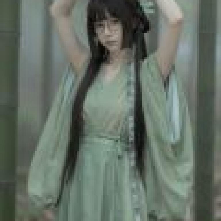 Beauty in the book，Woman in green dress with long hair and glasses.