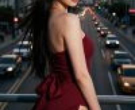 Red Temptation，A girl is wearing a red dress and standing in front of a road.