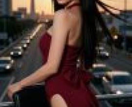 Red Temptation，A woman standing by a road full of cars.