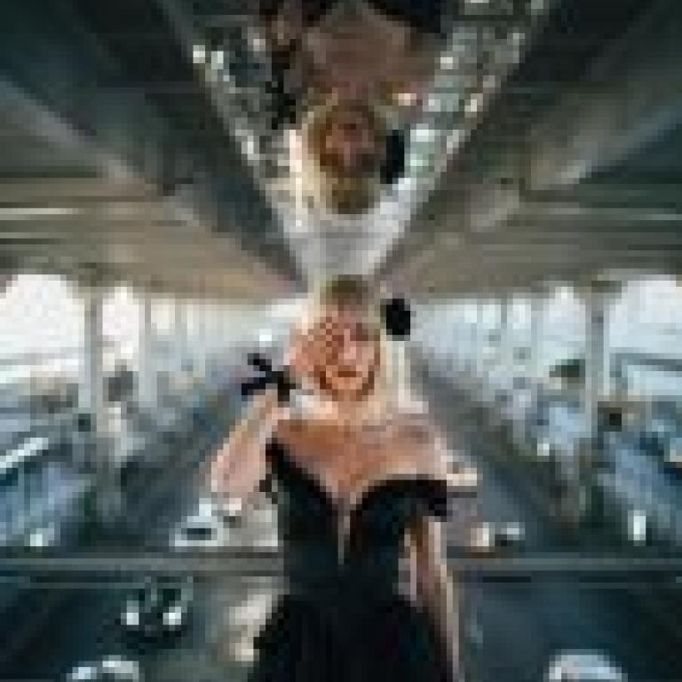 Black flowers on the road，Girl is standing on bridge.