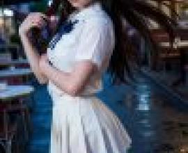 Special occupations，A girl in a white dress with her arms behind her back.