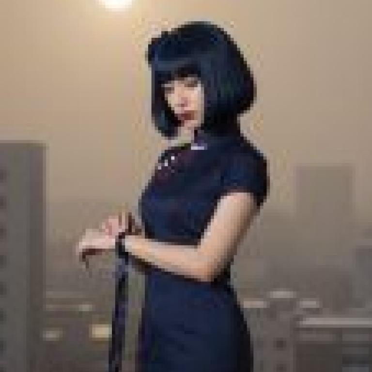 Magazine cover，Blue dress with bow on front and hair with dark bangs.