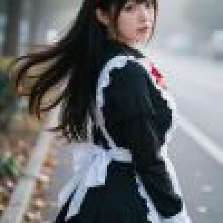 女孩們，這位小女孩穿著一件黑色連身裙，繫著一個紅色蝴蝶結。