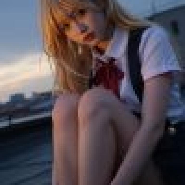 Street photography，A girl sitting on the ground with her hand in front of her.