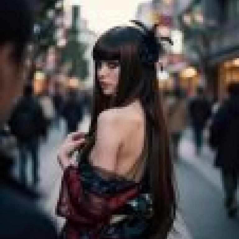 Photographers，Long hair woman in red and black dress with feathered headband.