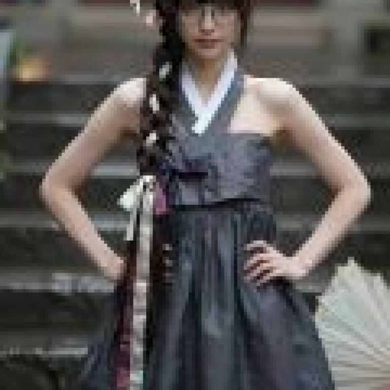 When I was in school，A woman is wearing a dress.