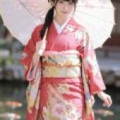 Cherry blossoms and kimonos，Model in red kimono standing in water.