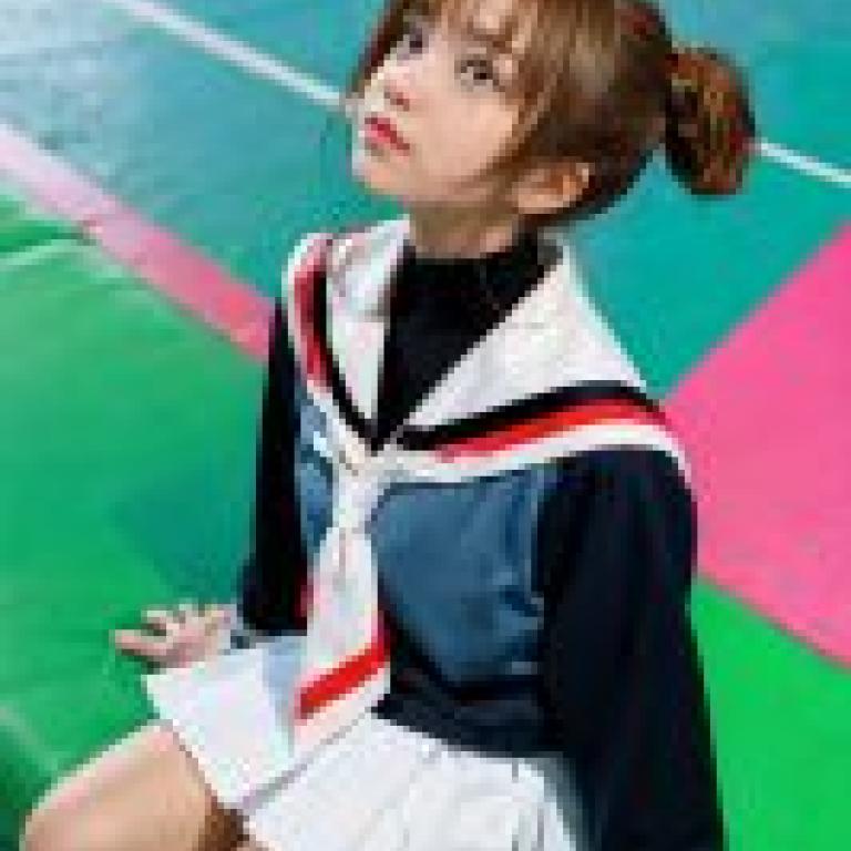 Nelvana of the series，Sakura Avalon，Girl with braids in school uniform sitting on floor.