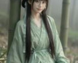 Beauty in the book，A girl with glasses and long dark hair in front of bamboo plants.