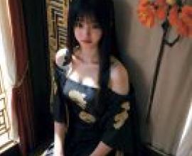 KyokofukadaGirl in dress sits on bench.