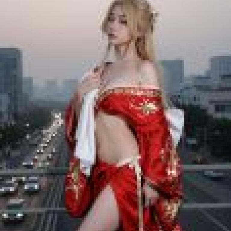 Time passed，A model of woman wearing red dress with gold design.