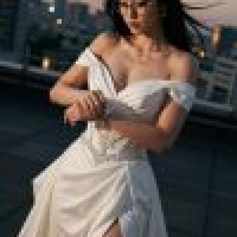 Dance of the Night，Woman in white gown and glasses.