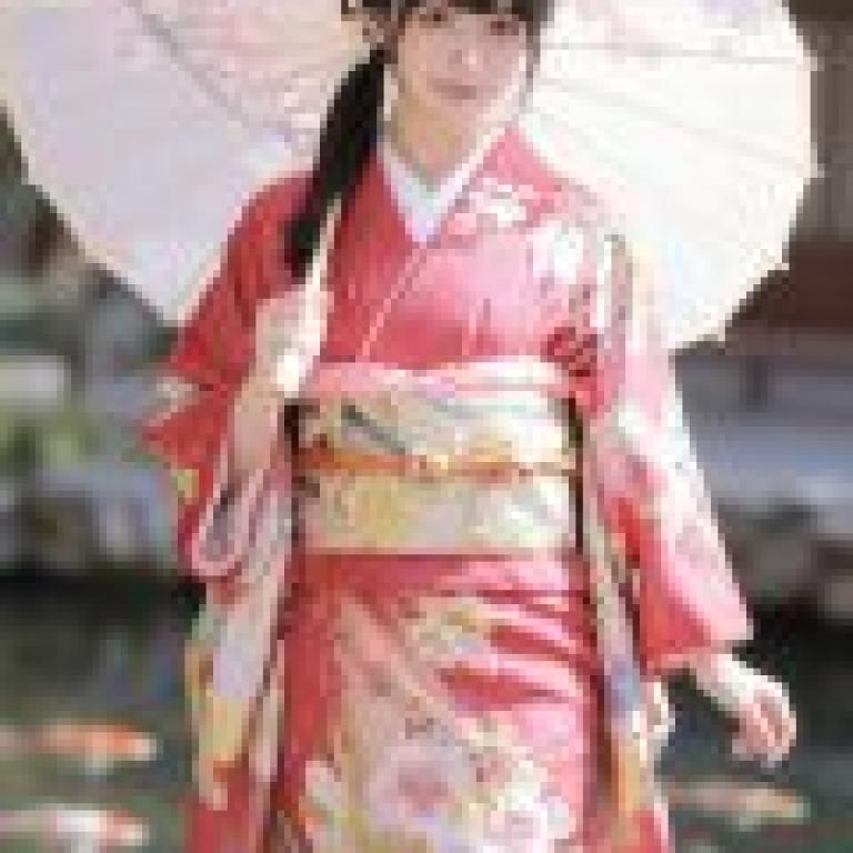 Cherry blossoms and kimonos，Model in red kimono standing in water.