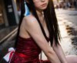 Street photography，A girl in glasses and red dress.