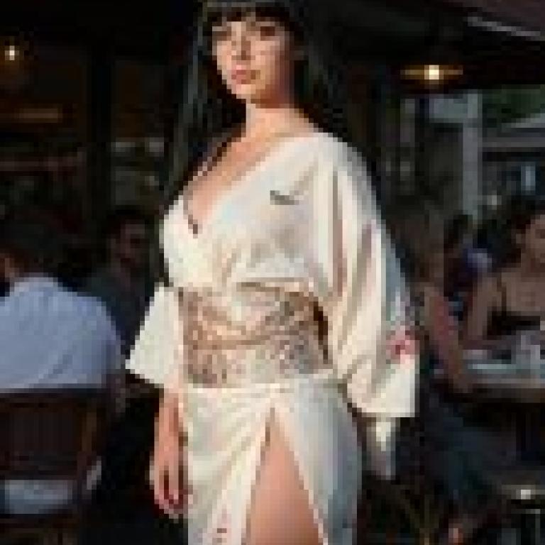Time passed，Girl in kimono with bird and bow sitting at table.