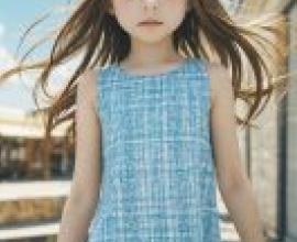 Rin Kaga  鹿賀 りん，Young girl in blue dress with long brown hair.