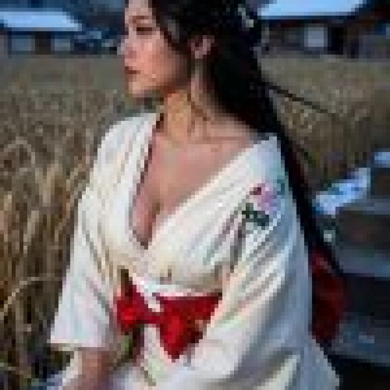 Kimono in the story，A woman sits in the snow with her hand on her lap.