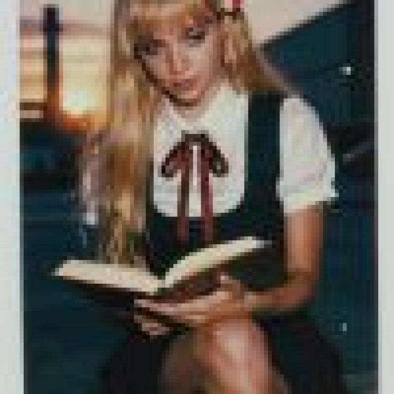 Uniform Story，Model of woman sitting and reading book.