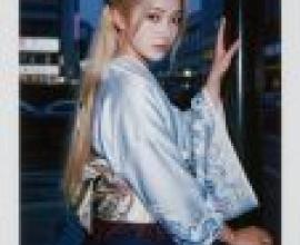 Time passed，A woman standing by a pole wearing an elegant dress.