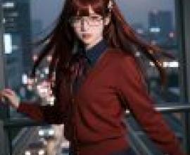 My favorite senior，A young woman with long brown hair poses for a photo in front of a city skyline.
