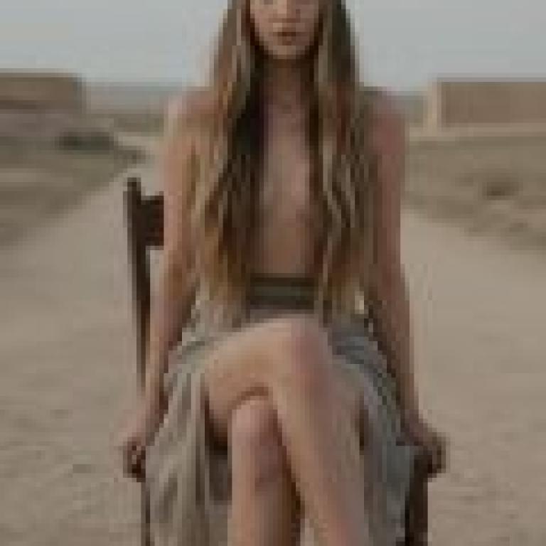 A post apocalyptic road trip，The girl is sitting in the chair.