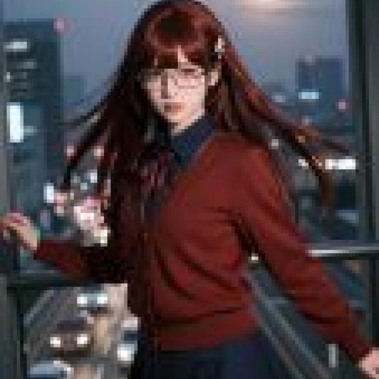 My favorite senior，A young woman with long brown hair poses for a photo in front of a city skyline.