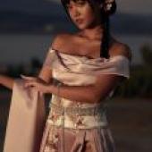 Exotic，A woman in a pink dress holding a cloth.