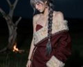 Memories of my trip to Tibet，Woman in red dress stands in front of campfire with her arms crossed.