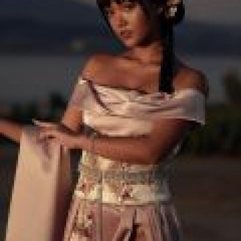 Exotic，A woman in a pink dress holding a cloth.