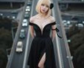 Black flowers on the road，A blonde woman in black dress with bow on hair.