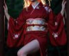 身穿和服的紅衣少女站在兩根柱子上。